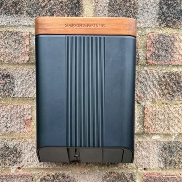 Simpson & Partners charger on light brick