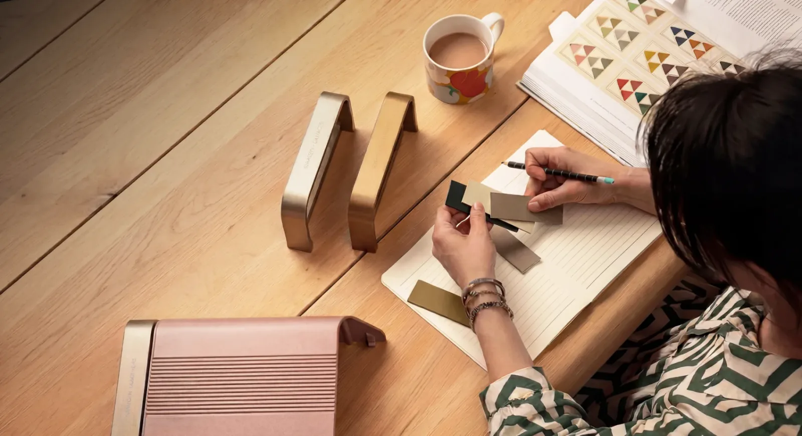 Designer reviewing colour swatches alongside a Home Series charger